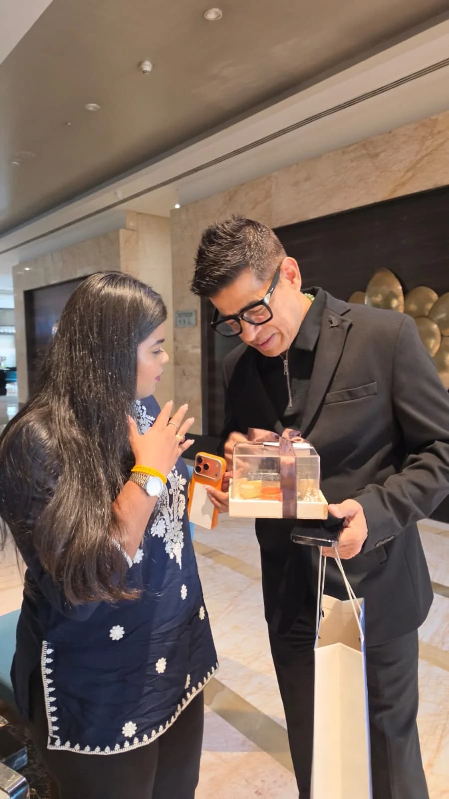 Shivangi sharing a gift hamper at an event